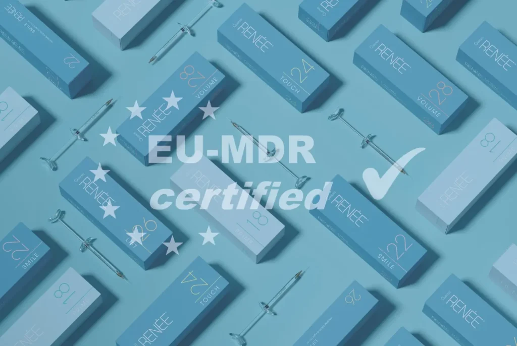 A background of blue and white boxes with the text "IRÉNÉE," along with various numbers and words like "VOLUME." The text "EU-MDR certified" is prominently displayed with stars and a checkmark. Syringes are interspersed among the boxes.