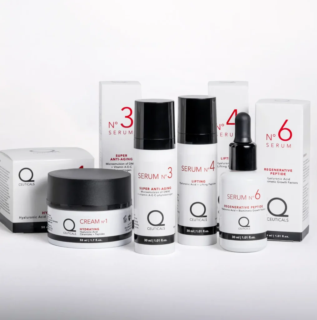 A collection of skincare products with black and white packaging, featuring creams, serums, and boxes labeled "Q-Ceuticals." Each product is numbered and features red text indicating different formulas and purposes.