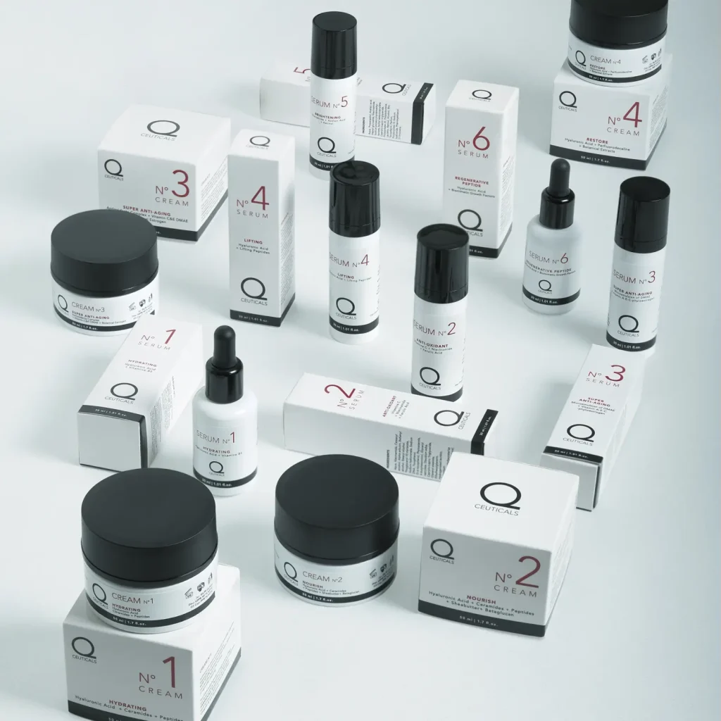 A collection of skincare products arranged on a white surface. The products include creams, serums, and boxes, all with minimalistic black and white packaging, labeled with numbers and product names.